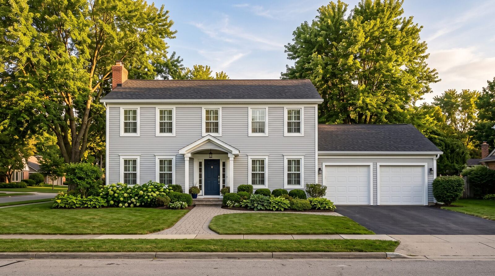 Two-story home with new siding, white aluminum fascia and seamless gutters