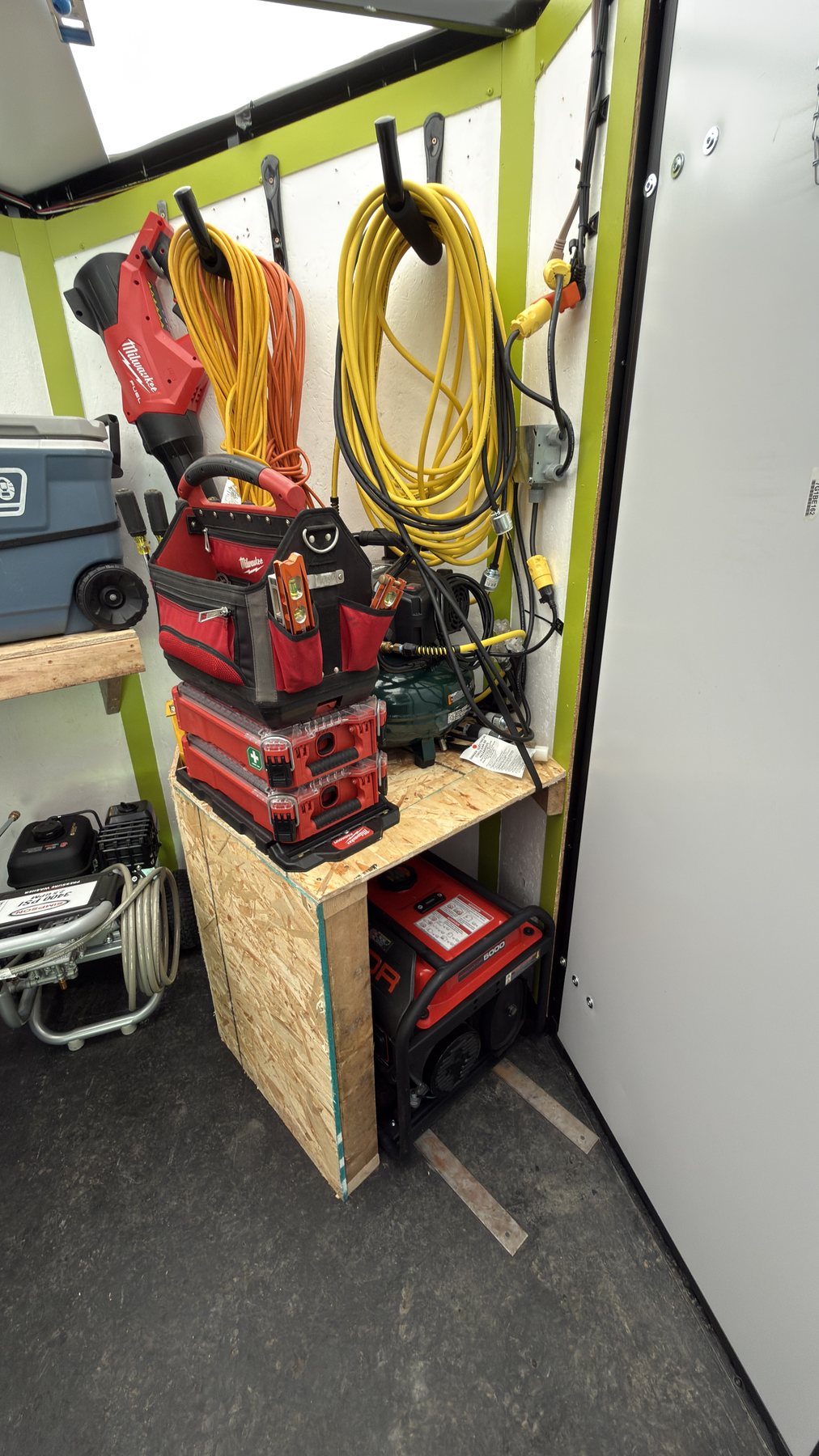 Generator, air compressor, extension cords and tool bag stored inside the trailer