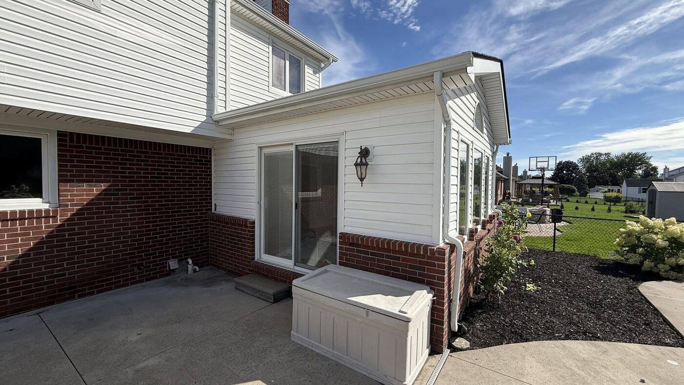 Real Rambow job: finished vinyl siding and wrapped gutter on a sunroom addition